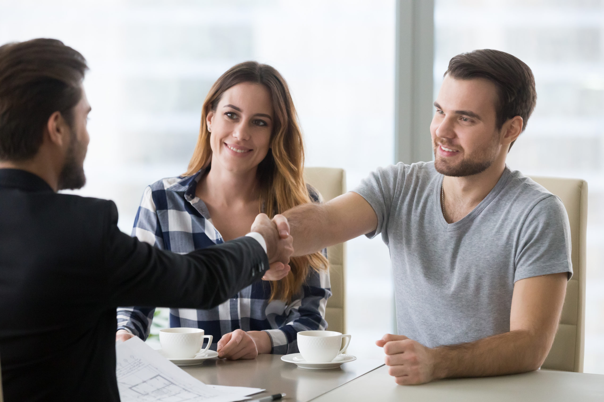 image of couple shaking hands with contractor